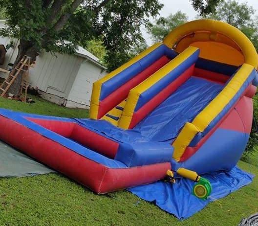 Bouncers R Us water slide bounce house set up in a San Antonio backyard